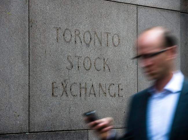 A man walks past a building in Toronto that used to house the Toronto Stock Exchange on Thursday, August 18 2011. THE CANADIAN PRESS/Aaron Vincent Elkaim.