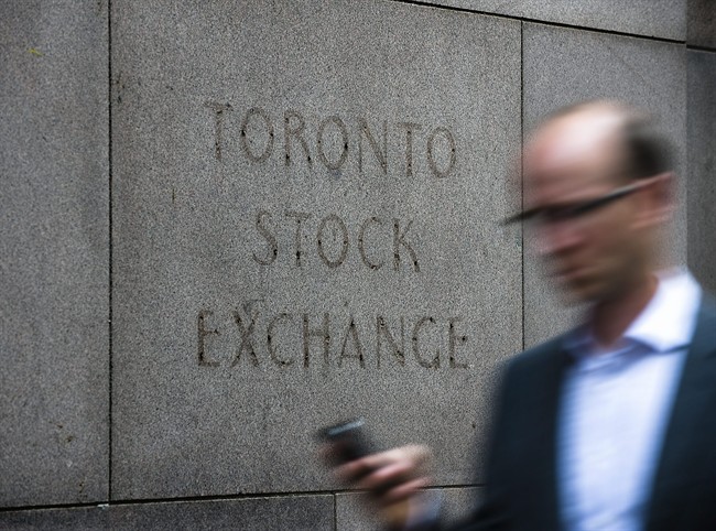 A man walks past a building in Toronto that used to house the Toronto Stock Exchange on Thursday, August 18 2011. THE CANADIAN PRESS/Aaron Vincent Elkaim.