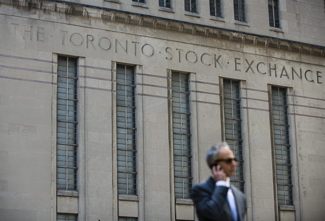 A man walks past a building in Toronto that used to house the Toronto Stock Exchange on Thursday, August 18 2011. THE CANADIAN PRESS/Aaron Vincent Elkaim.