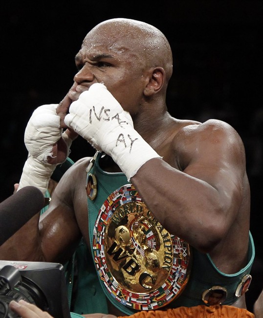 Floyd Mayweather Jr. blows kisses to the crowd after knocking out Victor Ortiz Floyd during their WBC welterweight title fight Saturday, Sept. 17, 2011, in Las Vegas. (AP Photo/Julie Jacobson).