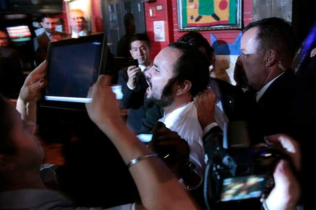An unidentified man is taken away by Secret Service agents after trying to disrupt President Barack Obama's remarks at a Democratic fundraiser at the House of Blues in West Hollywood, Calif., Monday, Sept., 26, 2011. (AP Photo/Pablo Martinez Monsivais).