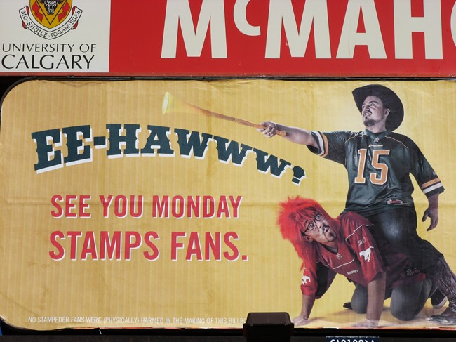 A billboard in the McMahon Stadium parking lot depicts an Edmonton Eskimo fan riding a Calgary Stampeder fan like a horse, on Thursday Sept. 1, 2011, in Calgary. The Stampeders (6-2) say they don't need extra motivation to want to beat the Eskimos (5-3). THE CANADIAN PRESS/ Donna Spencer.
