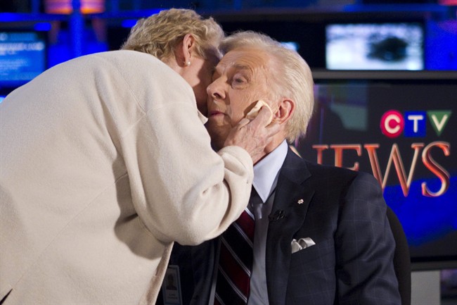 CTV news anchor Lloyd Robertson (right) is given a kiss by his long time make up artist Elaine Saunders ahead of his final newscast on Thursday Sept. 1, 2011. Robertson is retiring after 60 years in broadcasting including 35 as CTV's chief anchor and senior news editor. THE CANADIAN PRESS/Chris Young.