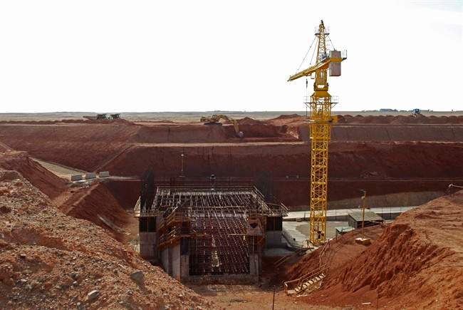 A crane hovers above the site of a new shaft under construction at the Ivanhoe Mines' Oyu Tolgoi mine site in Khanbogd village, Umnugobi province, Mongolia Saturday Nov. 7, 2009. Ivanhoe Mines (TSX:IVN) is defending the investment agreement for its Oyu Tolgoi project in Mongolia as a fair and legally binding contract.The Canadian mining company says the deal complies fully with all Mongolian laws and was negotiated in accordance with all resolutions issued by the Mongolian parliament. THE CANADIAN PRESS/AP, Ganbat Namjilsangarav.