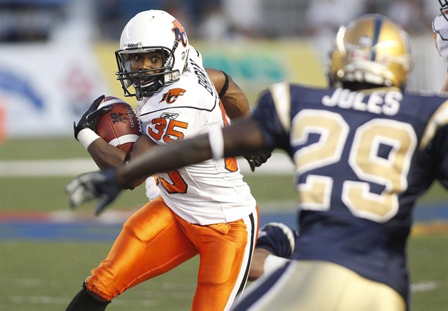 B.C. Lions' Tim Brown (35) runs against Winnipeg Blue Bombers' Jerry-Ralph Jules (29) in second half CFL action in Winnipeg, Thursday, July 28, 2011.The Lions are finding their legs and that's one reason why they are back climbing up the CFL standings. Running backs Andrew Harris and Tim Brown have been eating up the yards along the ground helping the Lions enjoy a four-game win streak. THE CANADIAN PRESS/John Woods.