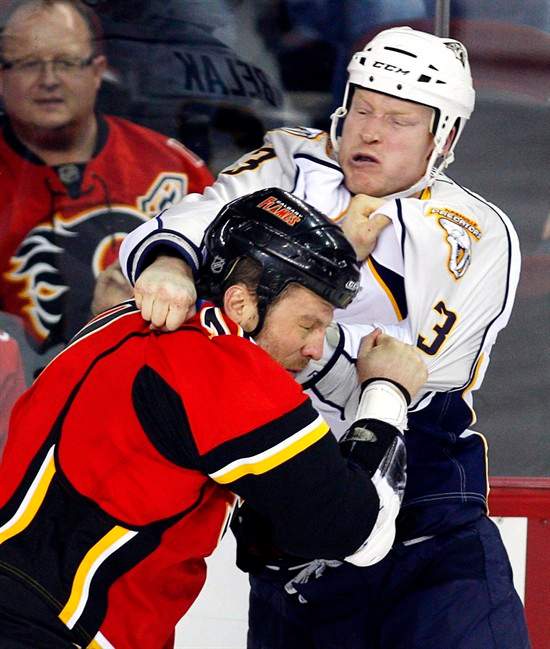 Nashville Predators' Wade Belak, right, fights with Calgary Flames' Brian McGratton during first period NHL hockey action in Calgary, Friday, Jan. 15, 2010. Toronto Police say they do not suspect foul play in the death of former NHL player Wade Belak. THE CANADIAN PRESS/Jeff McIntosh.