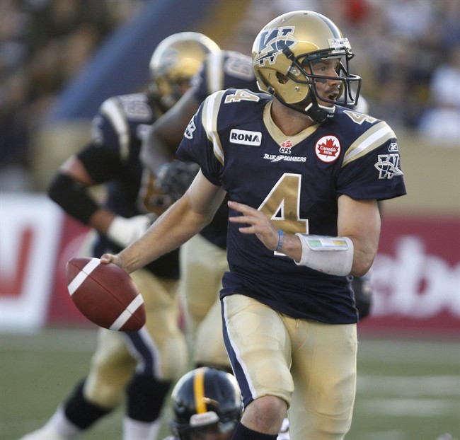 Winnipeg Blue Bombers' Buck Pierce rushes the ball against the Hamilton Tiger-Cats during the first half of CFL action in Winnipeg Friday, August 26, 2011. Pierce was back practising on Thursday and says he should be ready to play against the Alouettes in Montreal on Sunday.THE CANADIAN PRESS/Trevor Hagan.