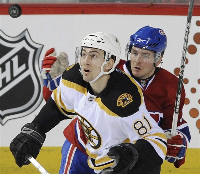 Boston Bruins' Miroslav Satan, left, and Montreal Canadiens' Brock Trotter look for a loose puck during third period NHL hockey action in Montreal, Sunday, Feb. 7, 2010. Trotter left the Montreal Canadiens' top farm team to try his luck with Dynamo Riga in the KHL last season. But the high-scoring forward from Winnipeg opted to come back and is impressing the coaches in camp with his improved skating and poise with the puck. THE CANADIAN PRESS/Graham Hughes.