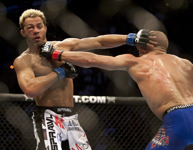 Georges St-Pierre, right, from Montreal, lands a left to the chin of Josh Koscheck, from Waynesburg, PA., during their welterweight title bout at UFC 124, December 12, 2010 in Montreal. Nine months after UFC welterweight Georges St-Pierre literally broke his face, Josh Koscheck climbs back into the cage Saturday Sept. 24, 2011. THE CANADIAN PRESS/Ryan Remiorz.