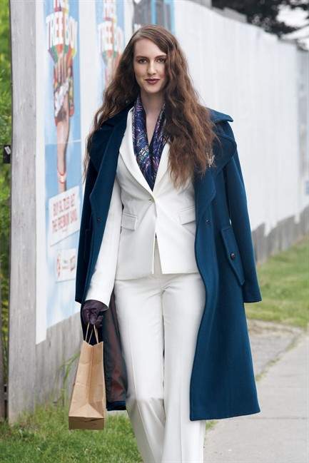 A woman wears urban work clothes.  