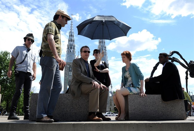 Director Don McKellar. second from left, and actor Bob Martin. third from right, work on the set the new CBC comedy "Michael: Tuesdays and Thursdays" in Ottawa on Monday, June 20, 2011. Bytown will get to show its hidden charms this year as the setting of the new CBC comedy, "Michael: Tuesdays & Thursdays" where the politics are in the bedroom and the office rather than the Hill.THE CANADIAN PRESS/Sean Kilpatrick.