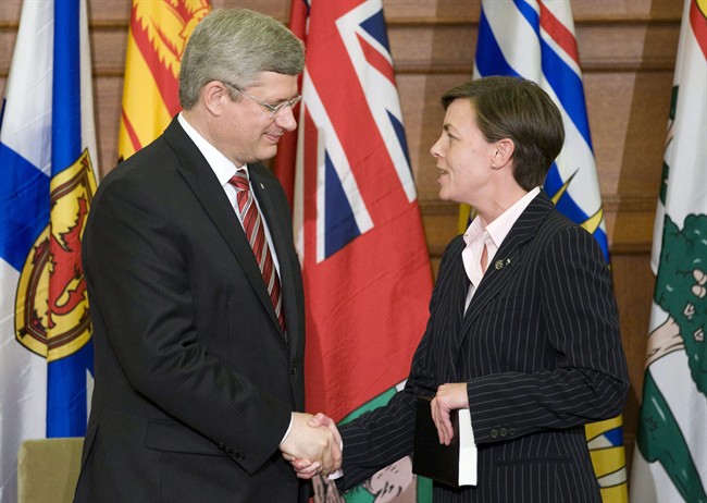 Prime Minister Stephen Harper shakes hands with Conservative MP Kellie Leitch after being sworn in on Parliament Hill in Ottawa, June 1, 2011. More than 40 people who have lost loved ones to asbestos-related disease have sent an open letter to rookie Ontario MP Kellie Leitch. THE CANADIAN PRESS/Adrian Wyld.