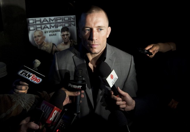 UFC welterweight champion Georges St-Pierre speaks to reporters during a press conference in Toronto Tuesday, September 6, 2011. THE CANADIAN PRESS/Darren Calabrese.