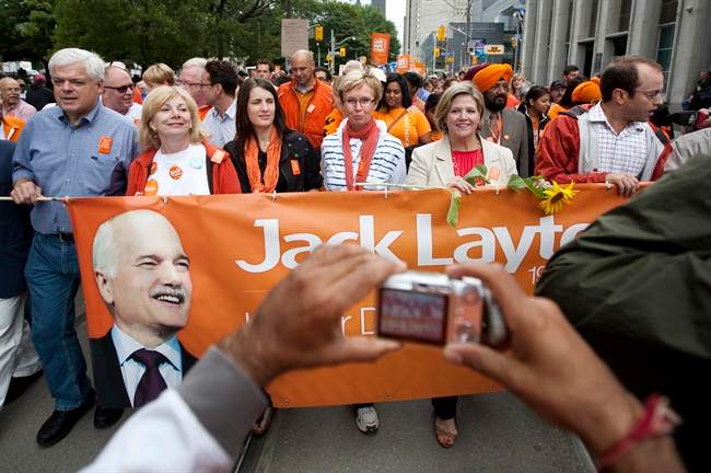 A supporter photographs, from right to left, Mike Layton, Ontario NDP Leader Andrea Horwath, interim Federal NDP Leader Nycole Turmel, and Sarah Layton while marching in Toronto's Labour Day parade in memory of Jack Layton Monday, September 5, 2011. THE CANADIAN PRESS/Darren Calabrese.