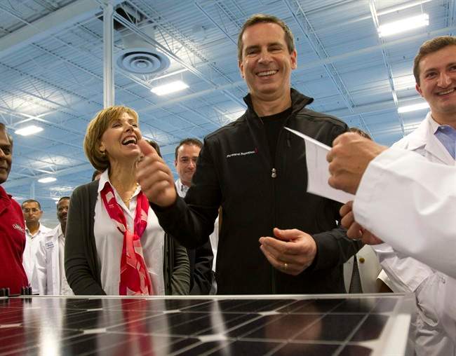 Ontario Liberal leader Dalton McGuinty and his wife Terri laugh after inspecting a solar panel during a campaign stop at Eclipsall Energy in Toronto on Tuesday September 13, 2011. THE CANADIAN PRESS/Frank Gunn.