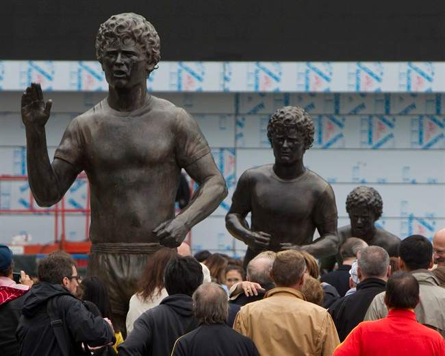 Spectators gather around statues of Terry Fox at the newly refurbished Terry Fox Plaza in downtown Vancouver, Friday, Sept. 16, 2011. THE CANADIAN PRESS/Jonathan Hayward.