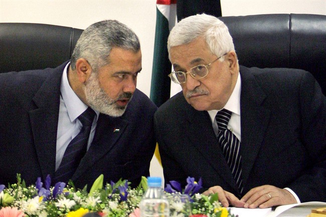 FILE- In this March 18, 2007 file photo, Palestinian Authority President Mahmoud Abbas, right, and Palestinian Prime Minister Ismail Haniyeh of Hamas, left, speak as they head the first cabinet meeting of the new coalition government at Abbas' office in Gaza City. Mahmoud Abbas' surge of popularity, following his bid for United Nations recognition of a state of Palestine on Friday, Sept. 23, 2011, is giving the Palestinian leader a stronger hand against rival Hamas as they prepare to resume talks on a stalled power-sharing deal next week. (AP Photo/Khalil Hamra, File).