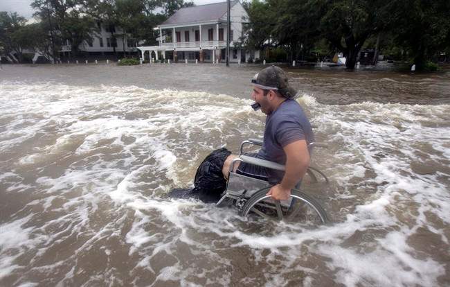 Cecil Flemming tries to maneuver his wheelchair through the waters on the Mandeville, La. lakefront of Lake Pontchartrain after waters crashed over the seawall from Tropical Storm Lee, on Sunday, Sept. 4, 2011. The vast, soggy storm system spent hours during the weekend hovering in the northernmost Gulf of Mexico. Its slow crawl to the north gave more time for its drenching rain bands to pelt a wide swath of vulnerable coastline, raising the flood threat. (AP Photo/The Times-Picayune, Ted Jackson).