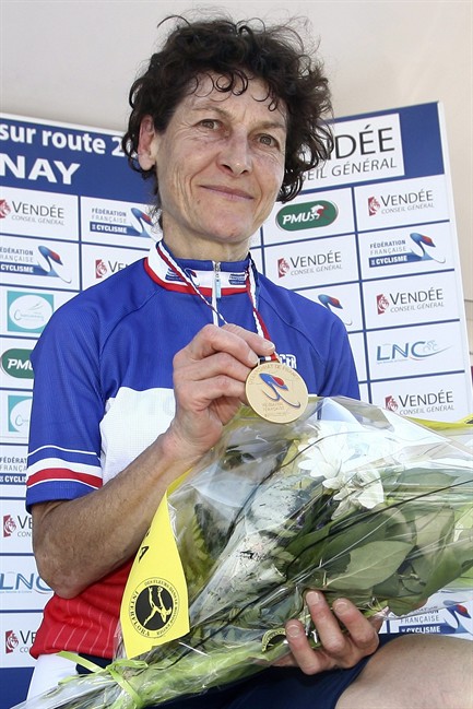 FILE -- This June 24, 2010 file photo shows Jeannie Longo on the podium displaying her gold medal after winning the 24.7 km race against the clock in the French cycling championship in Chantonnay, western France. A report in French sports newspaper L'Equipe says former Olympic and world champion cyclist Longo could face a maximum two-year suspension for breaking anti-doping rules requiring athletes to tell authorities where they can be located for testing. The report says the 52-year-old Longo broke the rules twice in the past 18 months and then again a third time on June 20, while training in the United States. (AP Photo/David Vincent, File).