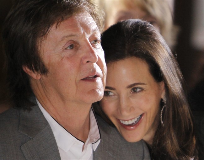 FILE - This is a Monday, Oct. 4, 2010 file photo of British musician Paul McCartney and his girlfriend Nancy Shevell as they watch Stella McCartney's spring-summer 2011 ready to wear fashion collection show in Paris. Paul McCartney is set to tie the knot at the venue where he first married more than 40 years ago. Officials said Friday Sept. 16, 2011 that the former Beatle and fiancee Nancy Shevell have posted a notice of intention to marry at London's Marylebone Register Office. (AP Photo/Thibault Camus).