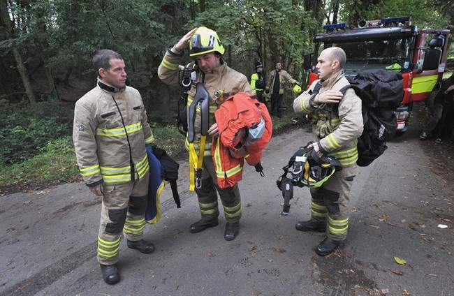 Rescue workers arrive at the Gleision Colliery near Swansea, south Wales as a body is located in the flooded mine Friday Sept. 16, 2011. British rescue workers found one miner dead after searching a flooded coal mine in south Wales, but pressed on Friday with the search for three others trapped underground. (AP Photo/Tim Ireland/PA Wire) UNITED KINGDOM OUT NO SALES NO ARCHIVE.