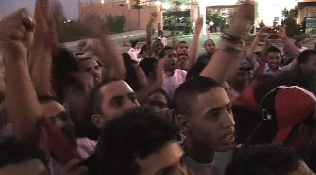 In this image made from television, Libyan soccer fans gather near to Martyr's Square in Tripoli, Saturday, Sept. 3, 2011, to watch Libya's national soccer team play Mozambique, in neighbouring Egypt, on a big screen, unseen. Playing its first game since the fall of Moammar Gadhafi, Libya's national soccer team beat Mozambique 1-0 Saturday in an African Cup of Nations qualifier. (AP Photo/APTN) TV OUT.