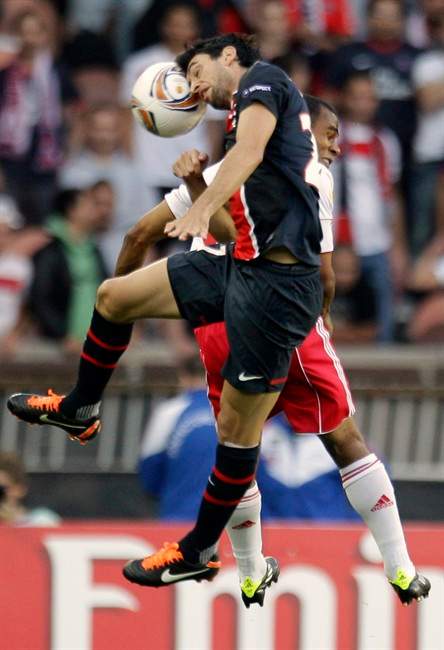 Paris Saint Germain's Javier Pastore, left, and Salzburg's Leonardo, right, head for the ball during the Europa League Group J match soccer match at Parc des Princes stadium in Paris, Thursday, Sept. 15, 2011. (AP Photo/Michel Euler).