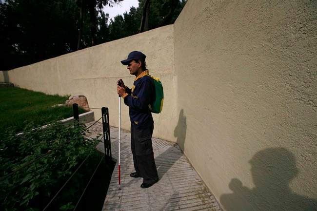 In this photo taken Sept. 7, 2011, Jose Sebastian is photographed by Guatemala's Rodrigo Telon Yucute at a park in Mexico City, Sept. 7, 2011. Both photographer and subject form part of the group of 30 visually impaired or blind people learning photography with the help of the Mexico City foundation Ojos Que Sienten, or Eyes That Feel. Telon Yucute is a former guerrilla fighter who lost his left forearm and his eyesight after a land mine exploded beneath him during Guatemala's civil war in the 1980's. (AP Photo/Rodrigo Telon Yucute).