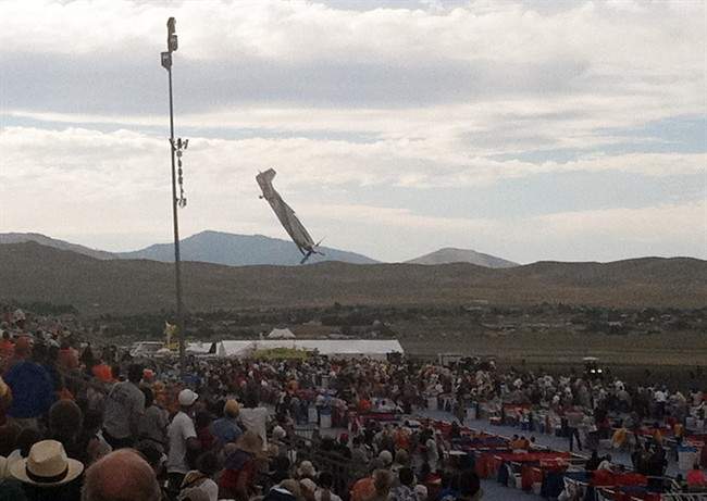In this Friday, Sept. 16, 2011 photo, a P-51 Mustang airplane approaches the ground right before crashing during an air show in Reno, Nev. The vintage World War II-era fighter plane piloted by Jimmy Leeward plunged into the grandstands during the popular annual air show. (AP Photo/Garret Woodson).