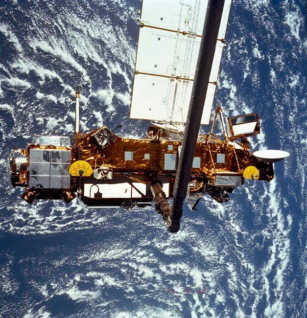 FILE - In this file image provided by NASA this is the STS-48 onboard photo of the Upper Atmosphere Research Satellite (UARS) in the grasp of the RMS (Remote Manipulator System) during deployment, from the shuttle in September 1991. NASA's old research satellite is expected to come crashing down through the atmosphere Friday afternoon, Sept. 23, 2011 Eastern Time. The spacecraft will not be passing over North America then, the space agency said in a statement Wednesday evening. (AP Photo/NASA).