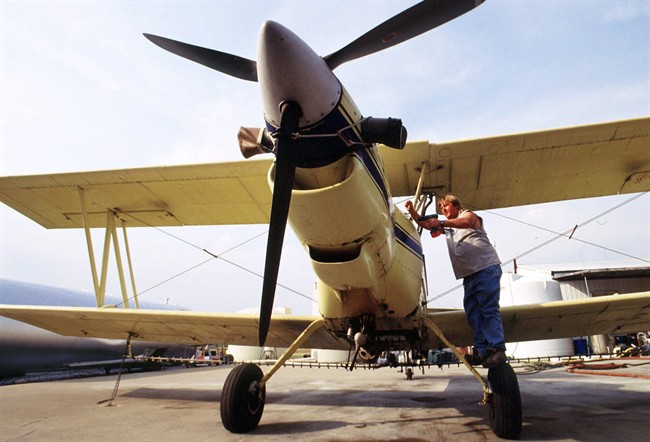 In this Monday, Sept. 17, 2001 file picture, Robert Williams of Mihand Aircraft near England, Ark., places the engine cover back on his agricultural airplane after removing the battery cable.