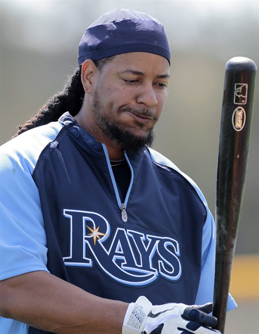 FILE - In this Feb. 21, 2011, file photo, former Tampa Bay Rays outfielder Manny Ramirez looks down at his bat after practice during spring baseball training at Charlotte Sports Park in Port Charlotte, Fla. Ramirez, a former World Series MVP, was arrested and booked Monday, Sept. 12, 2011, in Florida, but no charges were listed. (AP Photo/Dave Martin, File).