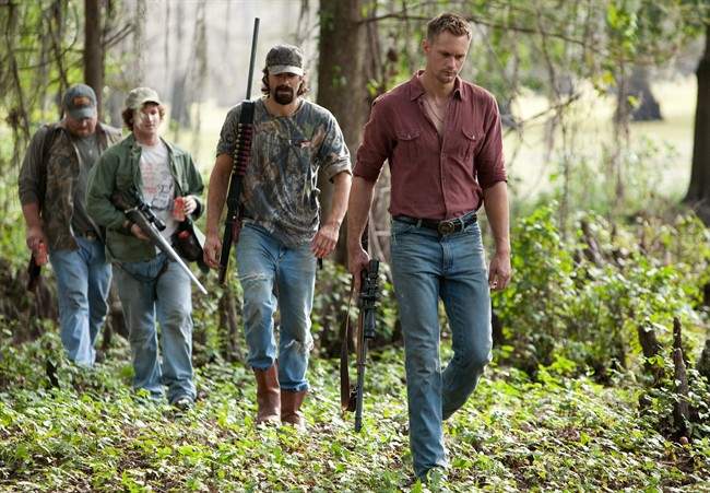 In this image released by Sony Screen Gems, from left, Drew Powell, Billy Lush, Rhys Coiro and Alexander Skarsgard are shown in a scene from "Straw Dogs." (AP Photo/Sony Screen Gems, Steve Dietl).