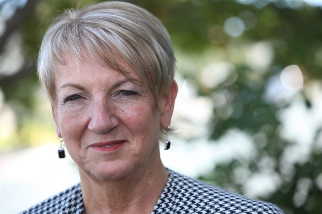 Newfoundland and Labrador Premier Kathy Dunderdale talks to media outside her home in St.John's, Monday, Sept.19, 2011. Dunderdale launched a bid for a third straight Conservative majority government on Monday with the start of a provincial election campaign scheduled for Oct. 11. THE CANADIAN PRESS/Paul Daly.