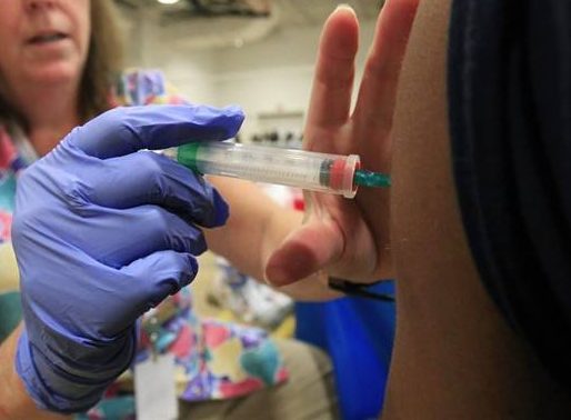 Nurse Susan Peel gives a whooping cough vaccination to a student at Inderkum High School, Monday, Sept. 19, 2011. (AP Photo/Rich Pedroncelli).