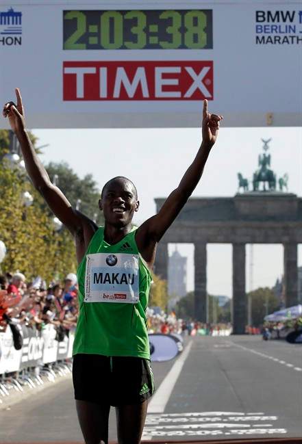 Patrick Makau from Kenia crosses the finish line to win the 38th Berlin Marathon in Berlin, Germany, Sunday, Sept. 25, 2011 in a new world record time of 2 hours, 3 minutes, 38 seconds. In background is the landmark Brandenburg Gate. (AP Photo/Michael Sohn).