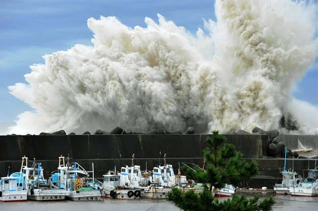 Surging waves hit against the breakwater in Udono in a port town of Kiho, Mie Prefecture, central Japan, Wednesday, Sept. 21, 2011. A powerful typhoon was bearing down on Japan's tsunami-ravaged northeastern coast Wednesday, approaching a nuclear power plant crippled in that disaster and prompting calls for the evacuation of more than a million people. (AP Photo/Chunichi Shimbun, Daiji Yanagida) JAPAN OUT, MANDATORY CREDIT, NO SALES.