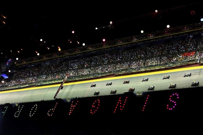 Red Bull driver Sebastian Vettel of Germany, left, top, leads the field at the start of the Singapore Formula One Grand Prix on the Marina Bay City Circuit in Singapore, Sunday, Sept. 25, 2011. (AP Photo/Raymond Ho).