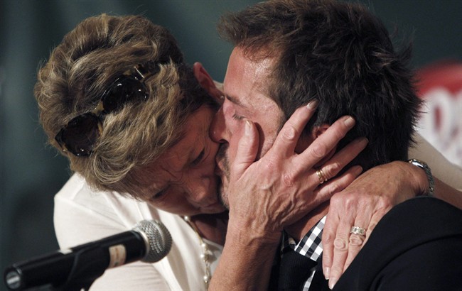 Mike Modano gets a comforting kiss and hug from his mother Karen Modano during a news conference announcing his retirement from professional hockey, Friday, Sept. 23, 2011, in Dallas. (AP Photo/LM Otero).