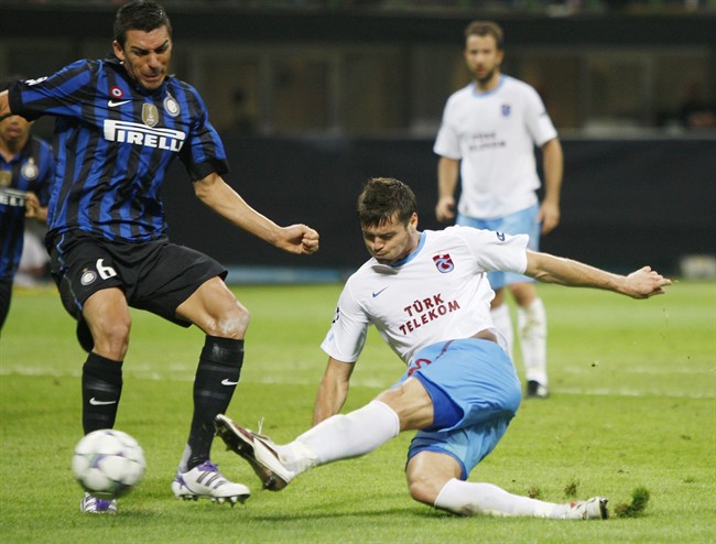 Trabzonspor defender Ondrej Celustka, right, of Czech Rpublic, scores a goal as Inter Milan Brazilian defender Lucio tries to stop him during a Champions League, group B soccer match, between Inter Milan and Trabzonspor at the San Siro stadium in Milan, Italy, Wednesday, Sept. 14, 2011. (AP Photo/Antonio Calanni).
