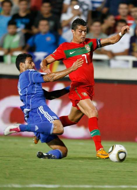 Cristiano Ronaldo (right) of Portugal fights for the ball with Merkis Georgios of Cyprus during their groupH UEFA Euro 2012 qualifying soccer match at the GSP stadium, in Nicosia,Cyprus, Friday, Sept. 2, 2011. (AP Photo/Philippos Christou).