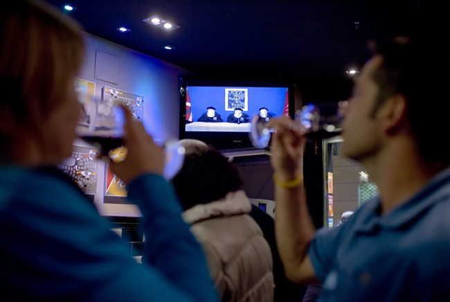 A couple drink whilst they look at Spanish TV at a bar in Pamplona northern Spain, Thursday Oct. 20, 2011 as it displays a video released by the Basque separatist group ETA. The Basque daily Gara says the armed group ETA has issued a statement Thursday Oct. 20, 2011 saying it is ending its armed campaign and calls on Spain and France to open talks. (AP Photo/Alvaro Barrientos).