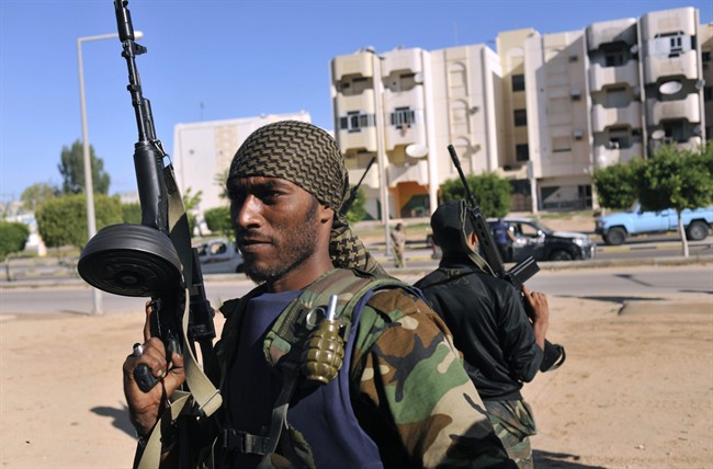 Libyan revolutionary fighters control downtown Sirte, Libya, Wednesday, Oct. 12, 2011. Rebel forces besieging Sirte since mid September fought loyalists in a fierce street by street fighting to control the home town of Libya's ousted leader Moammar Gadhafi. (AP Photo/Bela Szandelszky).