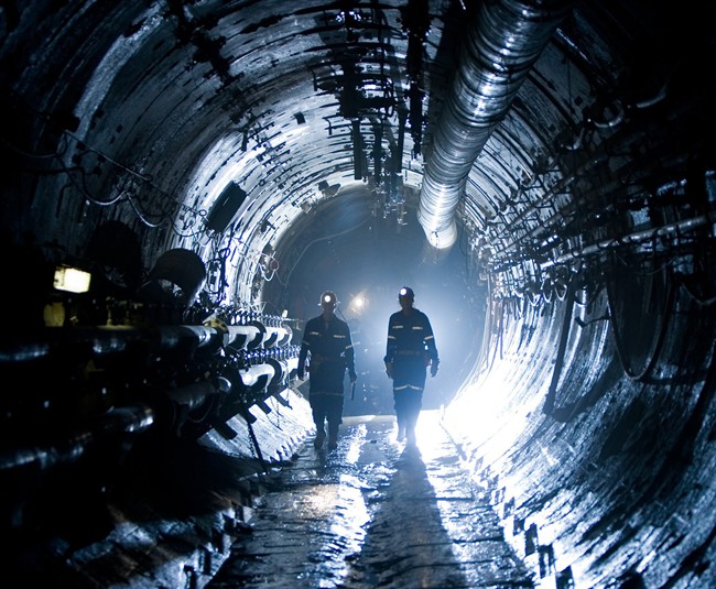 Workers walk in a reinforced underground tunnel at the Cigar Lake uranium mine in Saskatchewan, in ths company handout photo. THE CANADIAN PRESS/HO, Cameco.