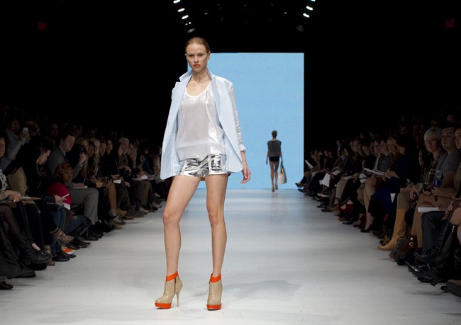 A model shows a creation by the designer Joeffer Caoc on the runway at Toronto Fashion Week on Tuesday October 18, 2011. THE CANADIAN PRESS/Chris Young.