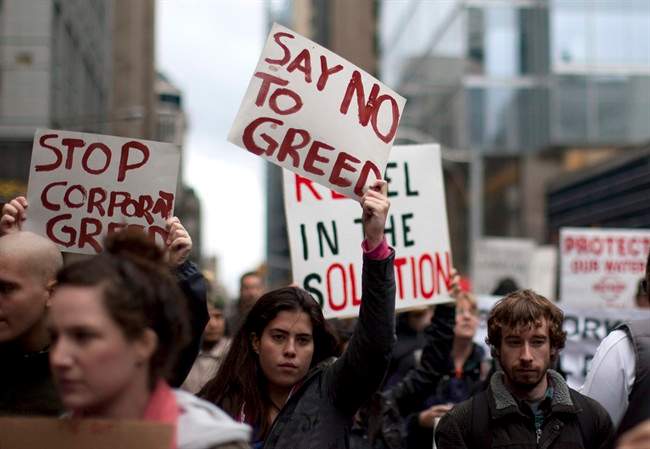 Protestors march near Toronto's financial district on Saturday October 15, 2011. A grassroots protest movement that began in the United States has crossed the border as Canadians across the country gathered to demonstrate against social inequality and corporate greed. THE CANADIAN PRESS/Chris Young.