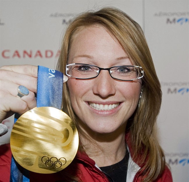 Canadian bobsledder Heather Moyse holds up her gold medal at Trudeau airport in Montreal, Monday, March 1, 2010, following her arrival from the Vancouver 2010 Olympic Winter games. Moyse is looking to score in a third sport.The 33-year-old from Summerside, P.E.I, who also plays for the Canadian women's rugby team, is turning her attention to track cycling. 