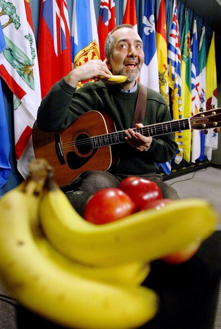 The noted Canadian children's singer Raffi is tweeting about the growing demonstrations across the United States and the ones about to begin in Canada. He is urging protesters to keep things peaceful and be guided by the spirit of Gandhi and Martin Luther King Jr. Raffi jokes around with a banana following a news conference on Parliament Hill in Ottawa Monday, Feb. 25, 2002. THE CANADIAN PRESS/ Jonathan Hayward.