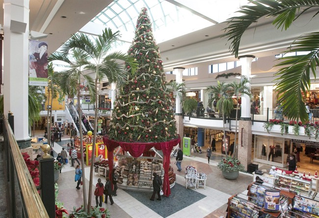 Christmas shoppers walk to stores at a shopping centre in Quebec City.