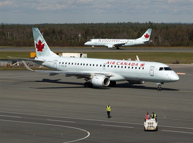 Two Air Canada jets taxi on the tarmac at the Halifax airport on Tuesday, Sept. 20, 2011. 